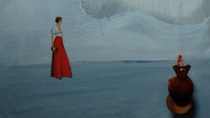 a blue and grey landscape painting with collaged female figure in a long red skirt . hanging in front of the painting is a pair of wooden castanets