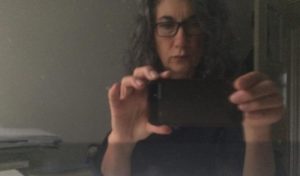 A woman taking a selfie in a mirror